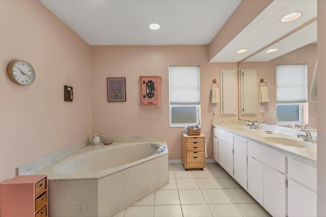 bathroom with tile patterned flooring, vanity, and a tub