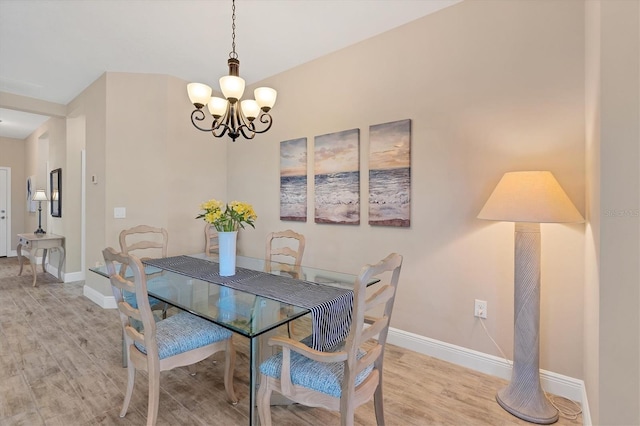 dining room with a chandelier and light hardwood / wood-style flooring