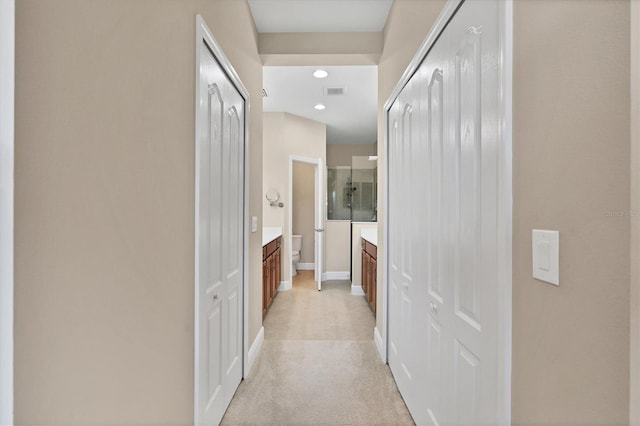 hallway featuring light carpet