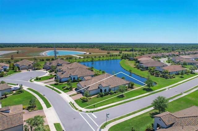 birds eye view of property with a water view