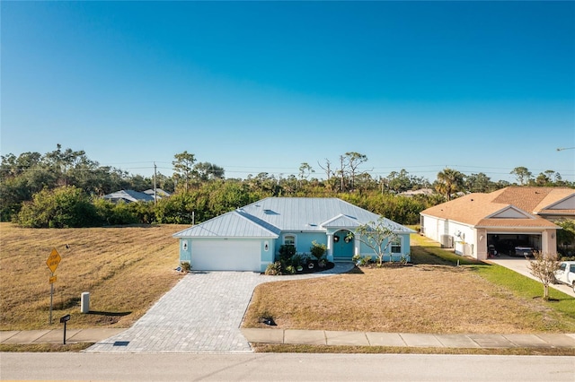 view of front of home with a front lawn and a garage