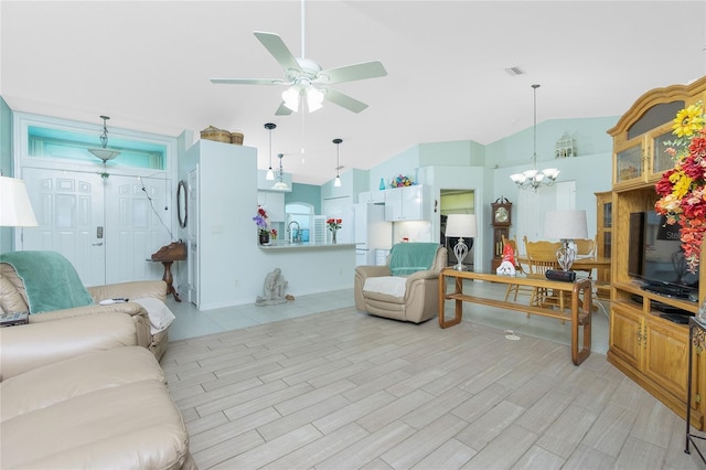 living room featuring ceiling fan with notable chandelier, light wood-type flooring, sink, and vaulted ceiling