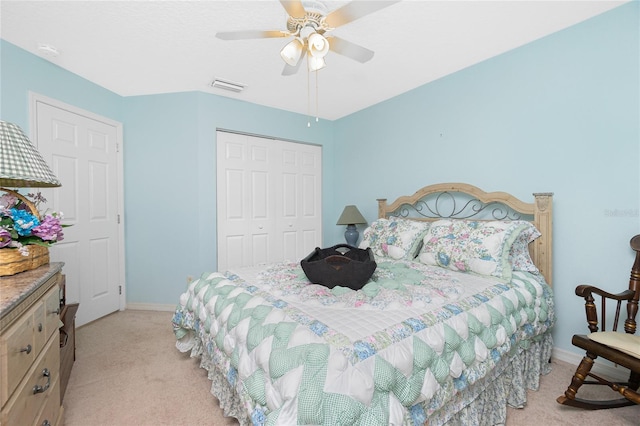 bedroom featuring light carpet, a closet, and ceiling fan