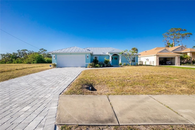 ranch-style home featuring a garage and a front lawn