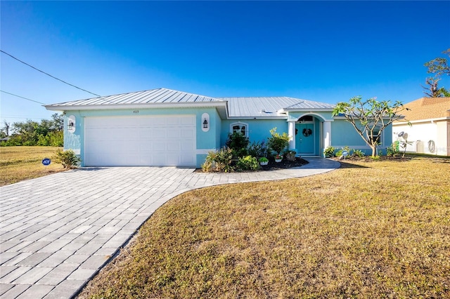 single story home featuring a garage and a front yard