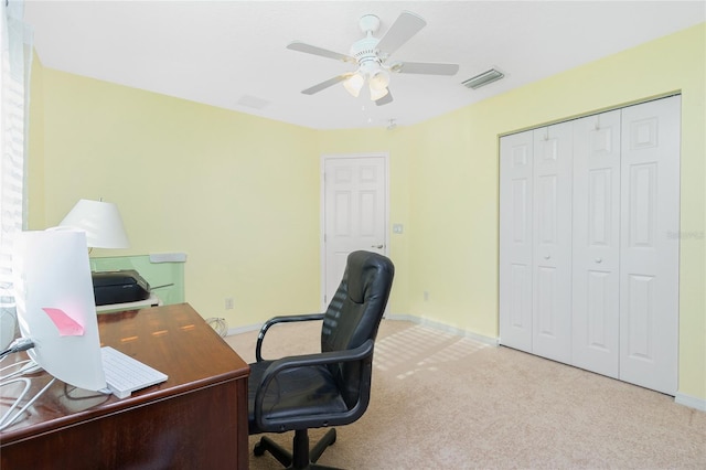 home office with light carpet and ceiling fan