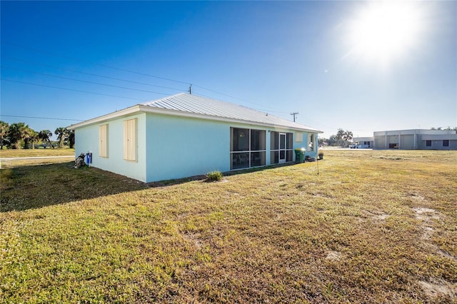 rear view of house featuring a lawn