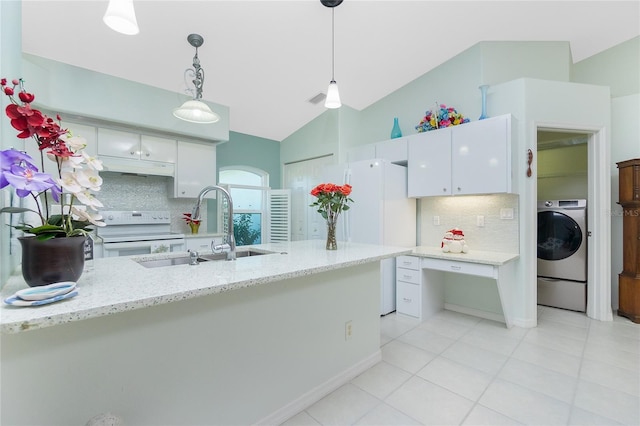 kitchen with white appliances, tasteful backsplash, white cabinets, washer / dryer, and vaulted ceiling