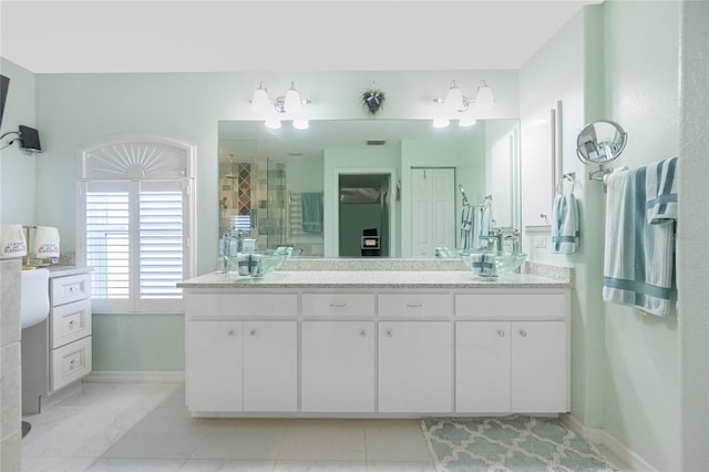 bathroom with vanity and a shower with shower door