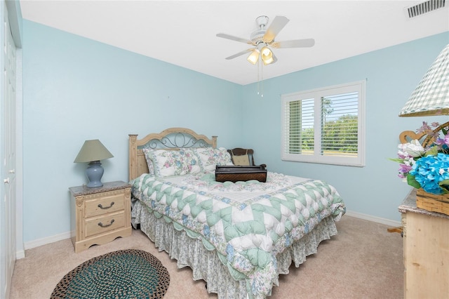 carpeted bedroom featuring ceiling fan and a closet