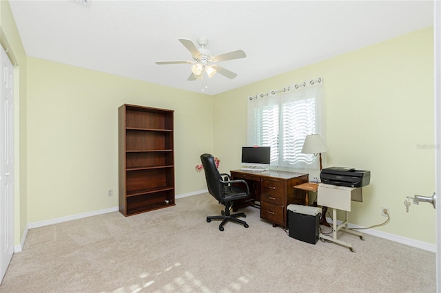 carpeted office featuring ceiling fan