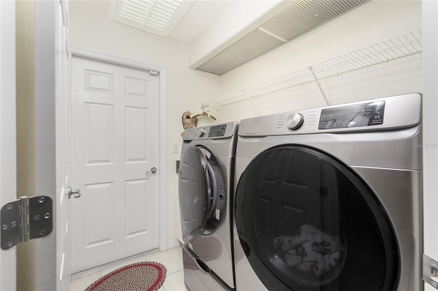 laundry area with separate washer and dryer and tile patterned floors