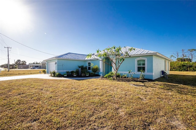 ranch-style home with a garage and a front yard