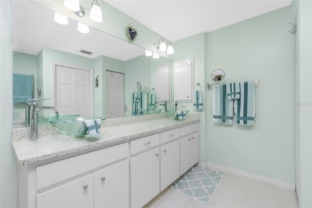 bathroom with tile patterned floors and vanity