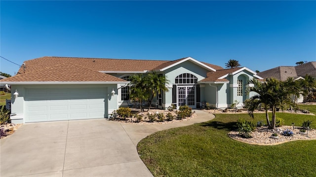 ranch-style home featuring a front yard and a garage