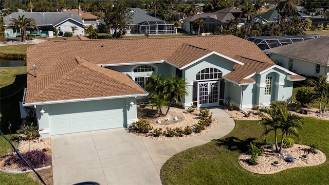 view of front facade with french doors, a front lawn, and a garage