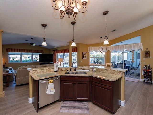 kitchen featuring dishwasher, sink, hanging light fixtures, vaulted ceiling, and light wood-type flooring