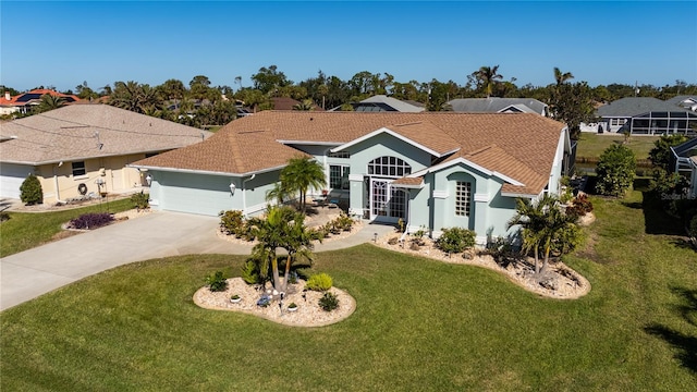 ranch-style home featuring a garage and a front lawn