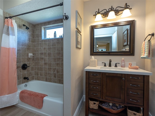 bathroom with vanity, shower / bathtub combination with curtain, a textured ceiling, and hardwood / wood-style flooring