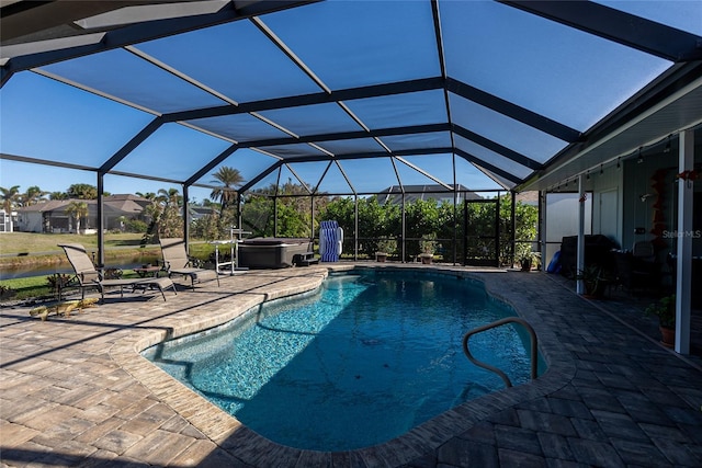 view of swimming pool with glass enclosure and a patio