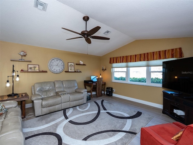 living room featuring ceiling fan, hardwood / wood-style floors, and vaulted ceiling