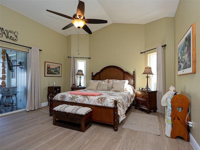 bedroom with light wood-type flooring, vaulted ceiling, and ceiling fan