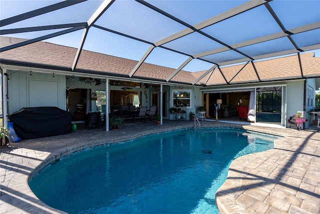 view of pool featuring a lanai, a patio area, ceiling fan, and grilling area