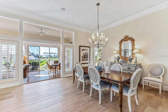 dining space with ceiling fan with notable chandelier, light wood-type flooring, and ornamental molding