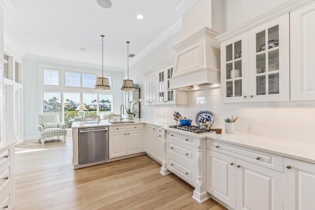 kitchen featuring sink, crown molding, light hardwood / wood-style flooring, white cabinetry, and stainless steel appliances