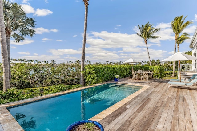 view of swimming pool with a deck