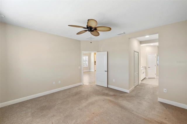 unfurnished room featuring light carpet and ceiling fan