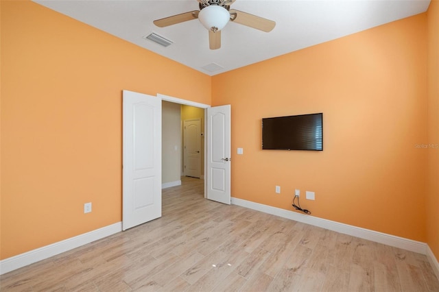 unfurnished bedroom with ceiling fan and light hardwood / wood-style floors