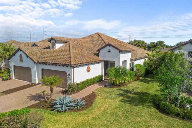 mediterranean / spanish-style house with a front lawn