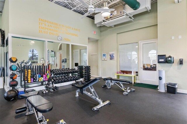 exercise room with a towering ceiling