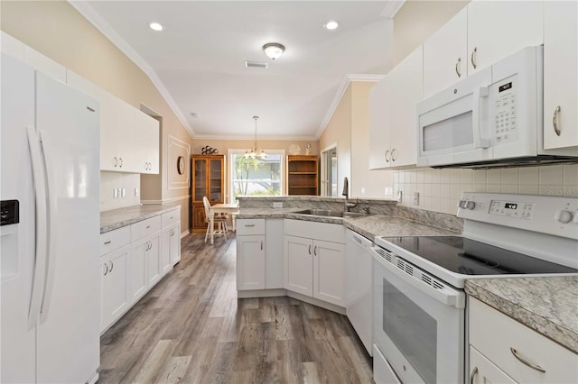 kitchen with white cabinetry, light hardwood / wood-style flooring, hanging light fixtures, and white appliances