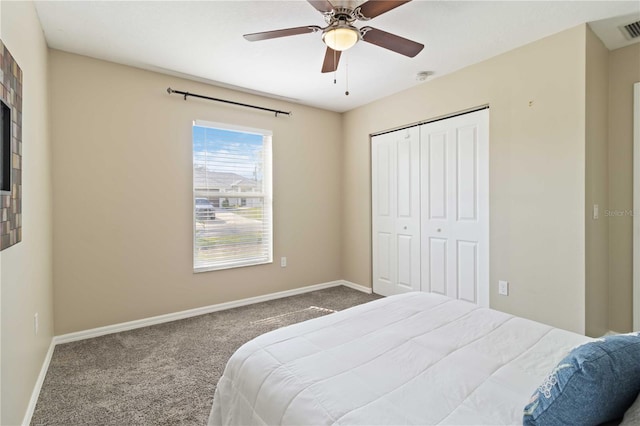 carpeted bedroom featuring a closet and ceiling fan