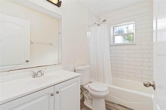 full bathroom featuring toilet, shower / bath combo with shower curtain, vanity, and hardwood / wood-style flooring