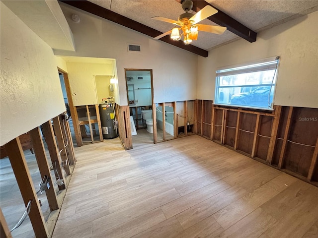 spare room with ceiling fan, water heater, lofted ceiling with beams, light hardwood / wood-style floors, and wood walls