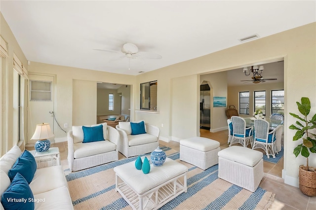 living room with a healthy amount of sunlight and ceiling fan