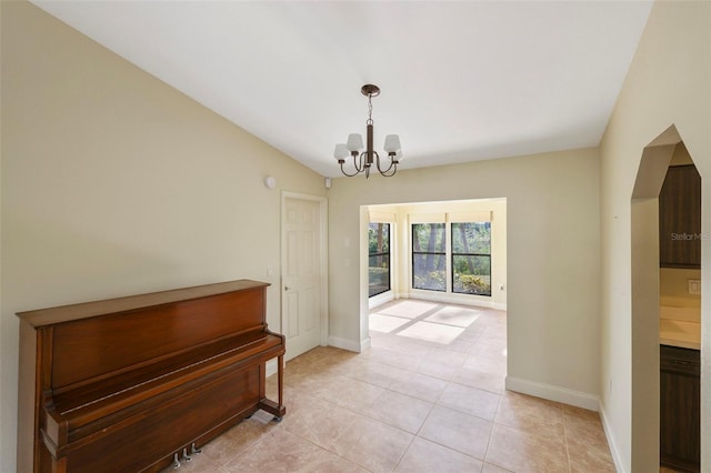 interior space with lofted ceiling and a notable chandelier