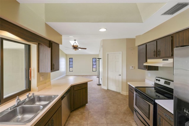 kitchen featuring sink, light tile patterned floors, ceiling fan, appliances with stainless steel finishes, and dark brown cabinetry