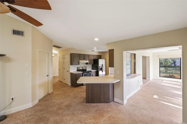 kitchen with stainless steel appliances, vaulted ceiling, ceiling fan, and dark brown cabinetry