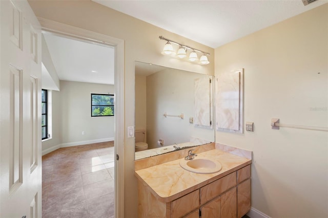 bathroom featuring vanity, tile patterned flooring, and toilet