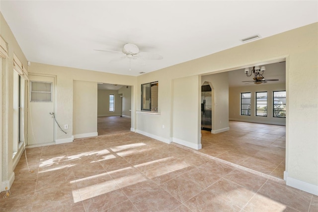 spare room featuring plenty of natural light and ceiling fan