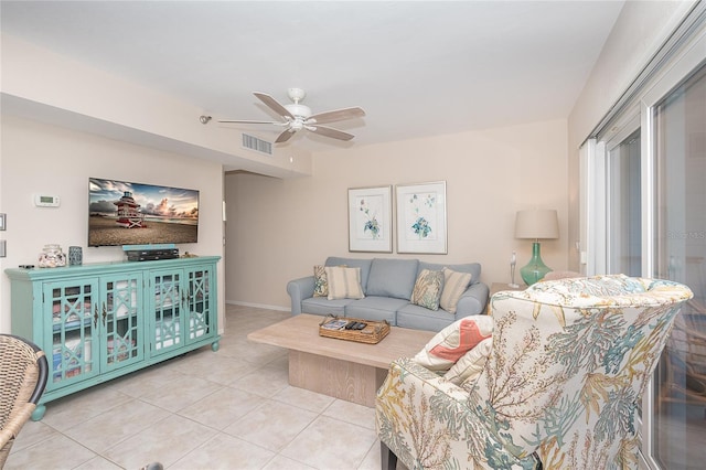 tiled living room with ceiling fan