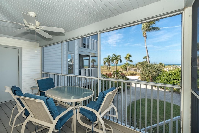 sunroom featuring ceiling fan and plenty of natural light