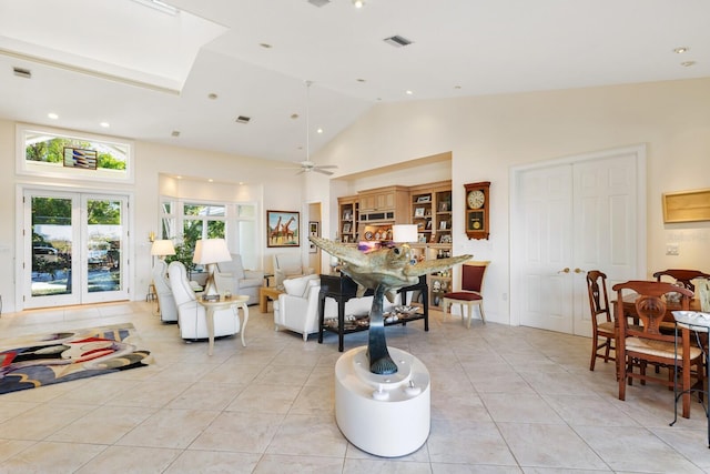 living room with ceiling fan, french doors, light tile patterned floors, and high vaulted ceiling