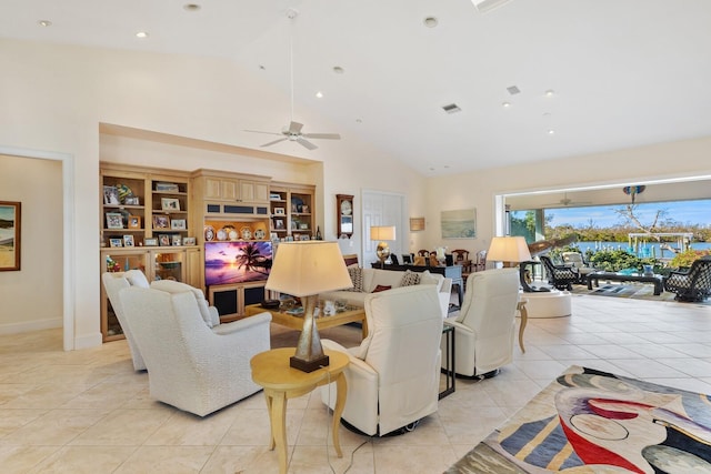 tiled living room with ceiling fan and high vaulted ceiling