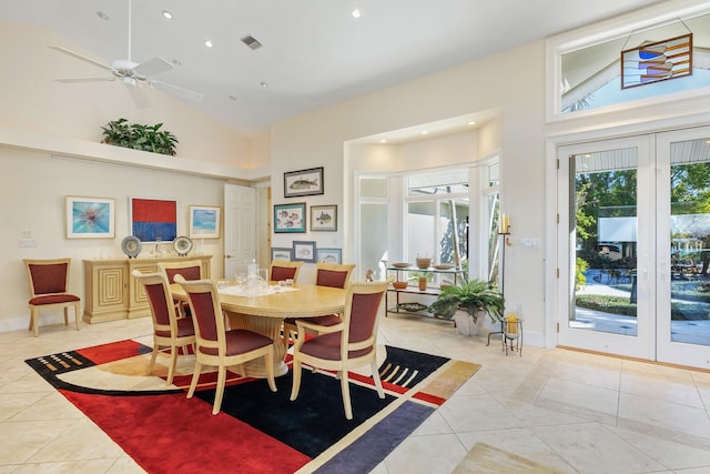 dining space featuring ceiling fan, light tile patterned floors, and high vaulted ceiling