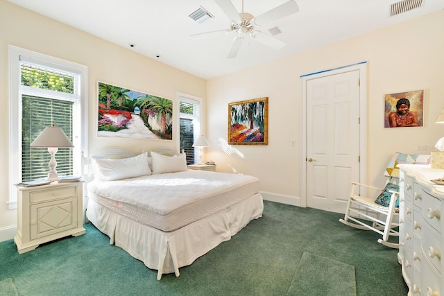 bedroom with ceiling fan and dark carpet